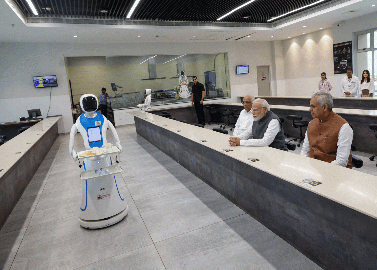 PM Modi with Robots Served Tea Sandwich in Gujarat Science City