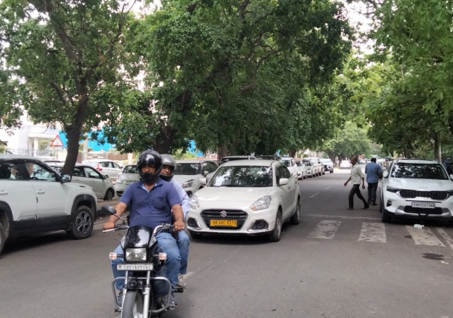 Vehicles are parked improperly on the road in Sector 6