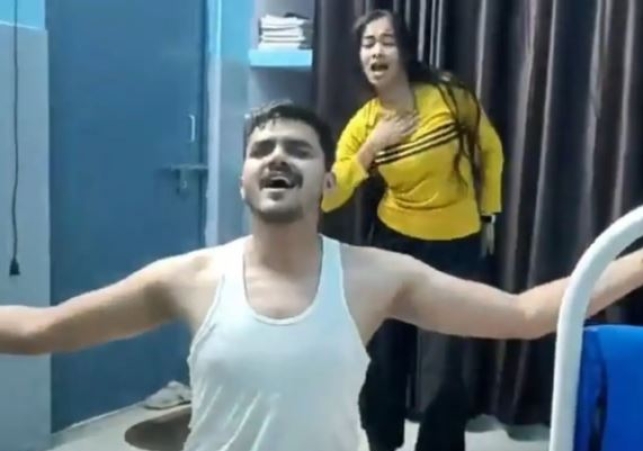 Doctor in vest and lower dances with young woman at CHC