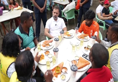 Rahul Gandhi rides pillion with delivery agent and also shares masala dosa with gig workers